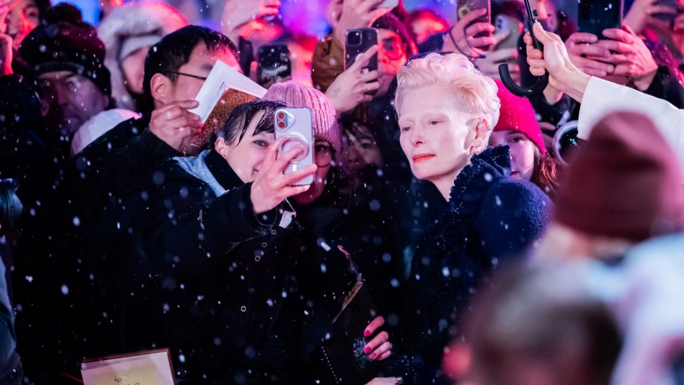 Tilda Swinton, Schauspielerin, lässt sich am Eröffnungsabend der Berlinale auf dem Roten Teppich mit Fans fotografieren.